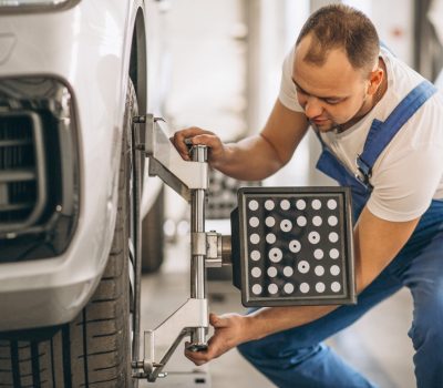 Auto mechanic checking car